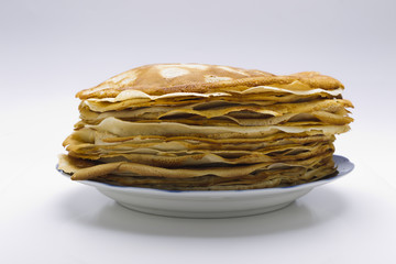 Pancakes on a plate on a white background