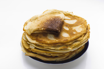 Pancakes on a plate on a white background