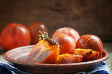 Sliced persimmon on a plate, selective focus