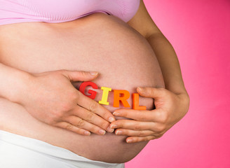 pregnant woman with word GIRL