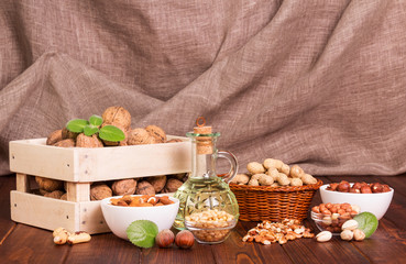 Different types of nuts closeup on brown background