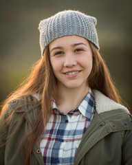 Teen Girl Wearing Hat and Smiling in Camera