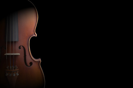 Old violin on black background.