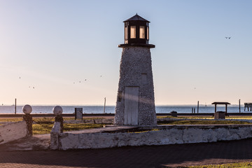 Buckroe Beach lighthouse in Hampton, Virginia with the ocean in the background.