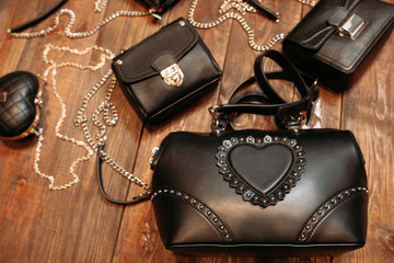 set of luxury leather handbags on wood