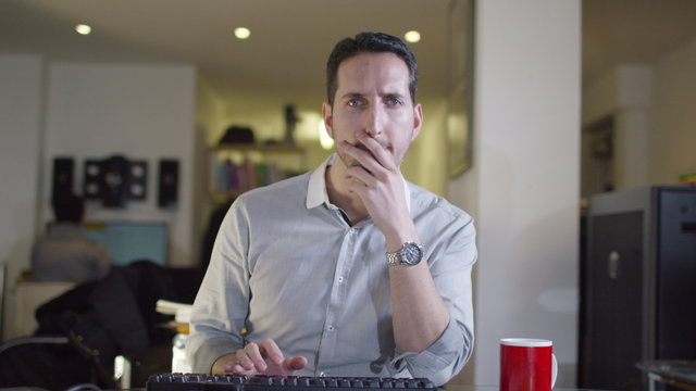  Office worker working at his computer as seen from computer screen's pov