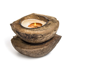 Candle in coconut on a white background