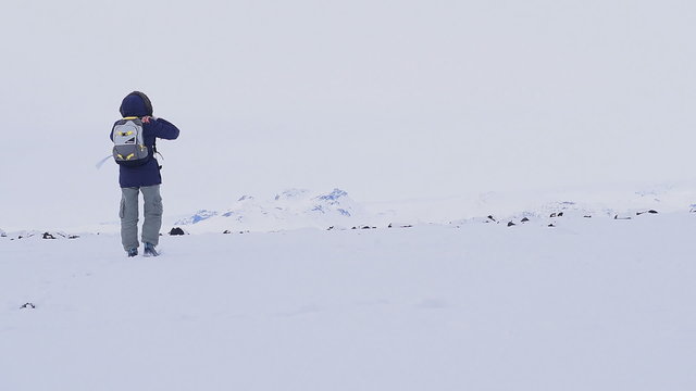 Woman running in the snow, enjoying winter holidays in the mountains of Iceland. Full HD Video 1920x1080