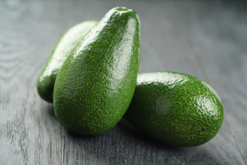 ripe green avocados on wood table