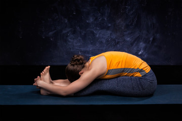 Sporty woman practices Ashtanga Vinyasa yoga asana 