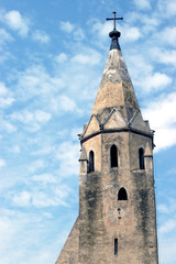 Fototapeta premium The bell tower of the church of a a small medieval village on th