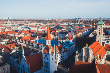 Beautiful super wide-angle sunny aerial view of Munich, Bayern, Bavaria, Germany with skyline and scenery beyond the city, seen from the observation deck of St. Peter Church 