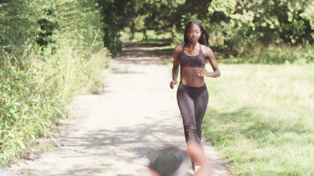 Young, sporty woman with personal trainer and stopwatch. slow motion