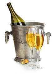 Champagne bottle with bucket ice and glasses of champagne, isolated on white. Festive still life.