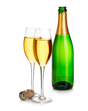 Two elegant champagne glasses on the background of green bottles close-up isolated on  a  white. Festive still life.