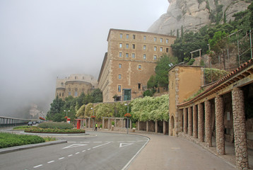 MONTSERRAT, SPAIN - AUGUST 28, 2012: Misty morning in the Benedictine abbey Santa Maria de Montserrat in Monistrol de Montserrat, Spain