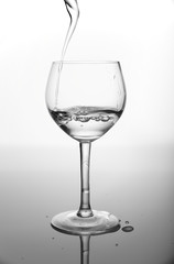 Filling a glass a wine on the dark background