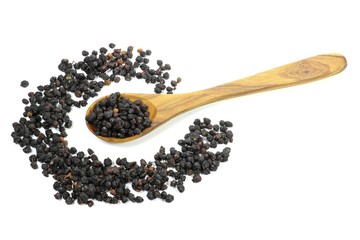 getrocknete Holunderbeeren mit einem Löffel aus Olivenholz isoliert auf weißem Hintergrund