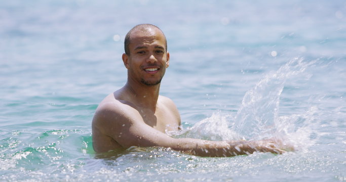  Portrait of attractive man at the beach, relaxing in the water. 