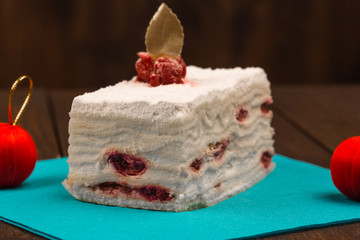 cake with fresh cherry on wooden background