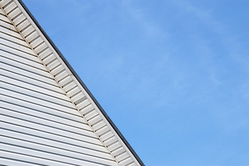 Fototapeta na wymiar Detail of the exterior facade house roof trimmed siding