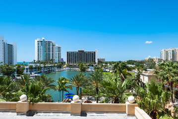 Luxury resort buildings at Sarasota Bay in Florida USA. Architectural residential condominiums for holidays and vacation with palm trees against blue sky background - 97903520