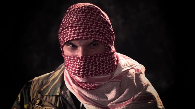 Balaclava angry terrorist with machine gun threat