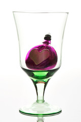 glass with toy on white background