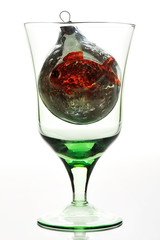 glass with toy on white background