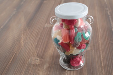 candy jar filled glass on a wooden table