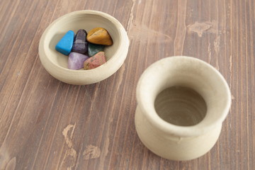 mineral colors on a clay bowl on a wooden table
