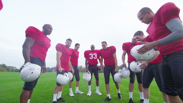  American football players in team talk, psyching themselves up for the game