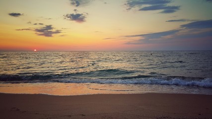 Naklejka na ściany i meble Lonely beach. Beautiful sunrise over the beach.