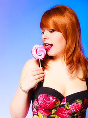 Woman with sweet candy lollipop in hand.