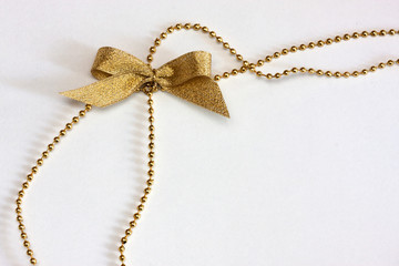 Golden bow on chain
