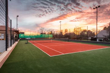 Wandaufkleber Tennis court at a private estate in the twilight and magic sky © poplasen