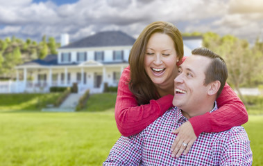 Fototapeta premium Happy Couple Outdoors In Front of Beautiful House
