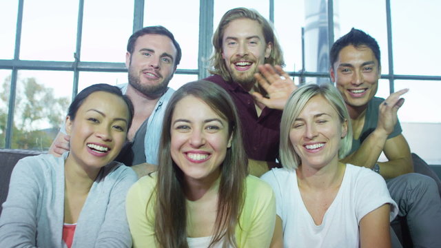 Attractive young people having a video chat with friends