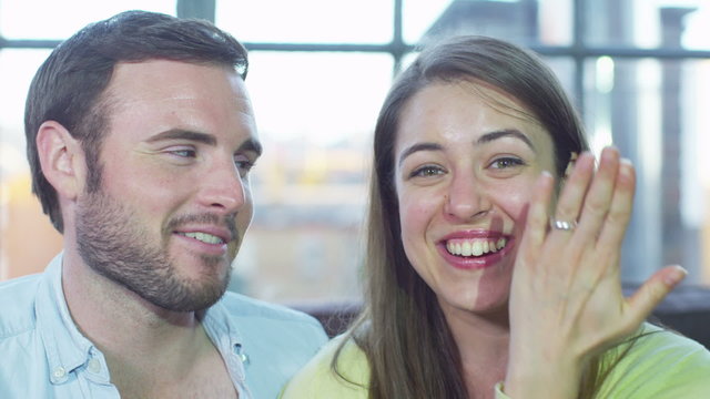 Attractive young couple having a video chat announcing their engagement 