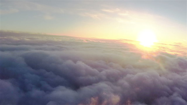 Real flight over clouds at  height of 1800 meters or 5905 ft. in sunset .Aerial  