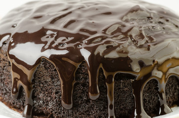 Dark chocolate sauce on top of dark chocolate cake