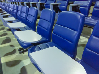 blue chairs seats in empty auditorium