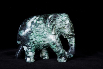 Jade sculpture of elephant isolated on black background