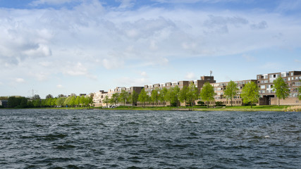 Obraz premium Apartment buildings around Weer water in Almere Stad