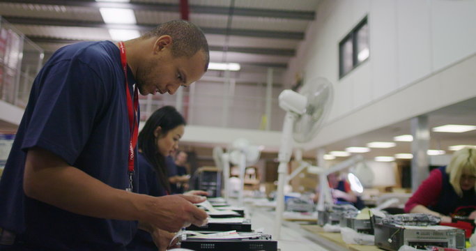 Workers building computers in a British electronics factory
