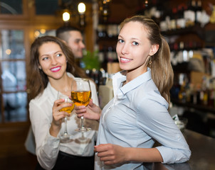 Young happy adults at bar