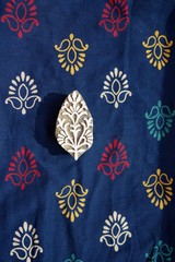Indian wood printing block with block printed textile background