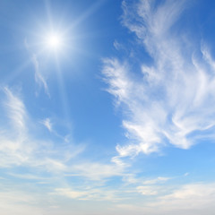 Fototapeta na wymiar sun on blue sky with white clouds