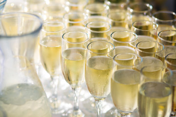 Beautiful row line of different colored alcohol cocktails with mint on a christmas party, martini, vodka with bubbles, wine and others on decorated catering bouquet table on open air event, picture 