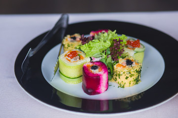Beautifully decorated catering banquet table with different food snacks and appetizers with sandwich, caviar, fresh fruits on corporate christmas birthday party event or wedding celebration 